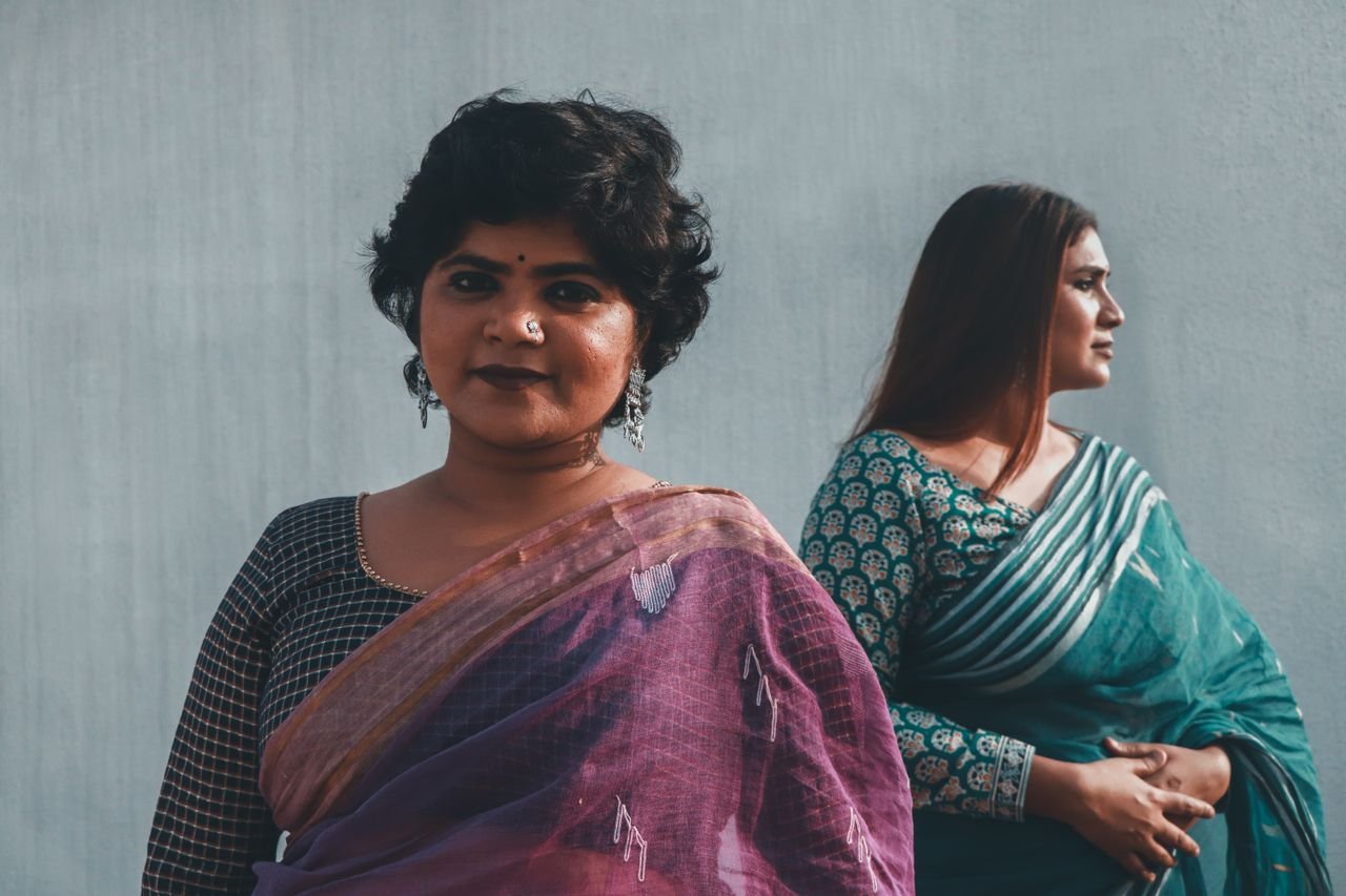 Portrait of two Indian women in traditional sarees, showcasing elegant style and cultural heritage.